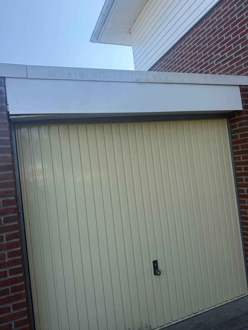 Garagedeur vóór reiniging — mos en aanslag